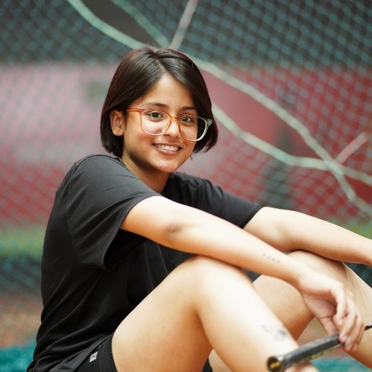 Avery Quinn, Lead Design Curator at Serenity Valley Garden, reviewing corporate floral arrangements